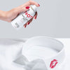 Juliette Has a Gun Not a Hair & Body Mist shown in hand spraying on a shirt with a lipstick imprint