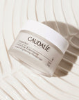 Caudalie Vinoperfect Instant Brightening Moisturizer (50 ml) on a background of product - texturized.
