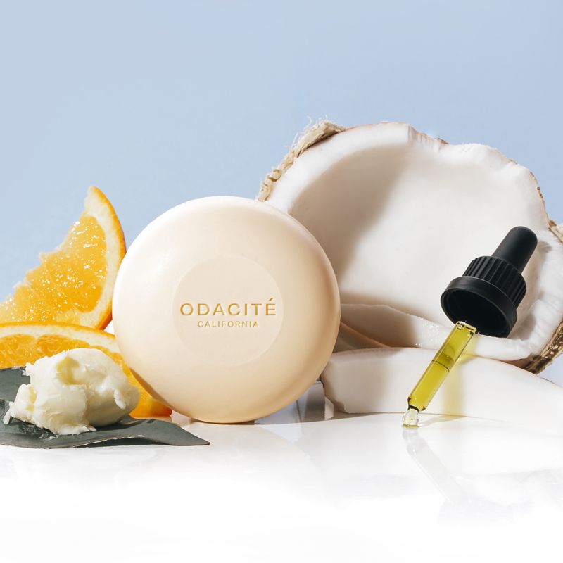 Odacite 552M Shampoo Bar beauty shot with ingredients shown (orange slices and coconut)