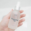 Mother Mother Magnesium Oil (4 oz) held in woman's hand