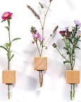Lifestyle shot with 3 Funnyfish Smart Tube Vase Bright Cubes with flower stems in them