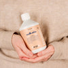 Close up shot of woman holding Kerzon Fragranced Laundry Soap - Maille Caline (16.67 oz)