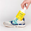 Model holding Kerzon Fragranced Laundry Soap - Gym Tonique (16.67 oz) sitting inside an athletic shoe