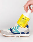 Model holding Kerzon Fragranced Laundry Soap - Gym Tonique (16.67 oz) sitting inside an athletic shoe