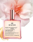 Nuxe Huile Prodigieuse Florale Multi-Purpose Dry Oil pictured with flower