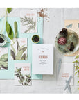 The Floral Society Herb Seed Kit - Lifestyle shot showing garden markers and seeds