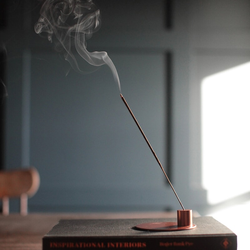 The Floral Society Rose Otto & Geranium Essential Oil Incense burning in holder (not included)