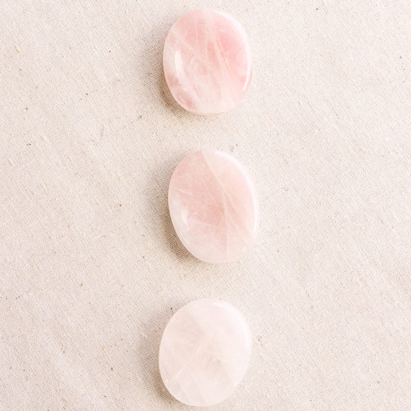 Tiny Rituals Rose Quartz Worry Stone showing 3 different examples of the worry stone (sold separately)