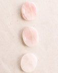 Tiny Rituals Rose Quartz Worry Stone showing 3 different examples of the worry stone (sold separately)