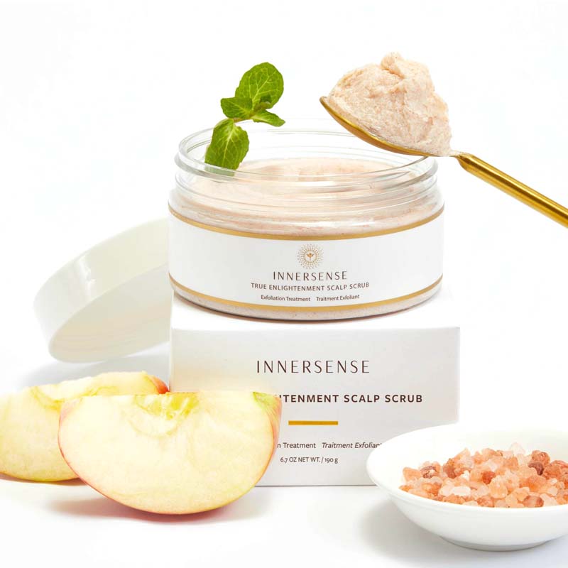 Beauty shot of Innersense True Enlightenment Scalp Scrub (190 g) with box gold spoon with scrub and ingredients in the background