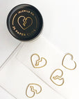 Idlewild Broken Heart Paper Clips (25 pcs) showing top of jar and 4 clips, one of which is clipped to an envelope