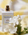 Lifestyle shot of Eau d'Italie Fior Fiore Eau de Parfum Spray (100 ml) with white flowers in the foreground and water splashing