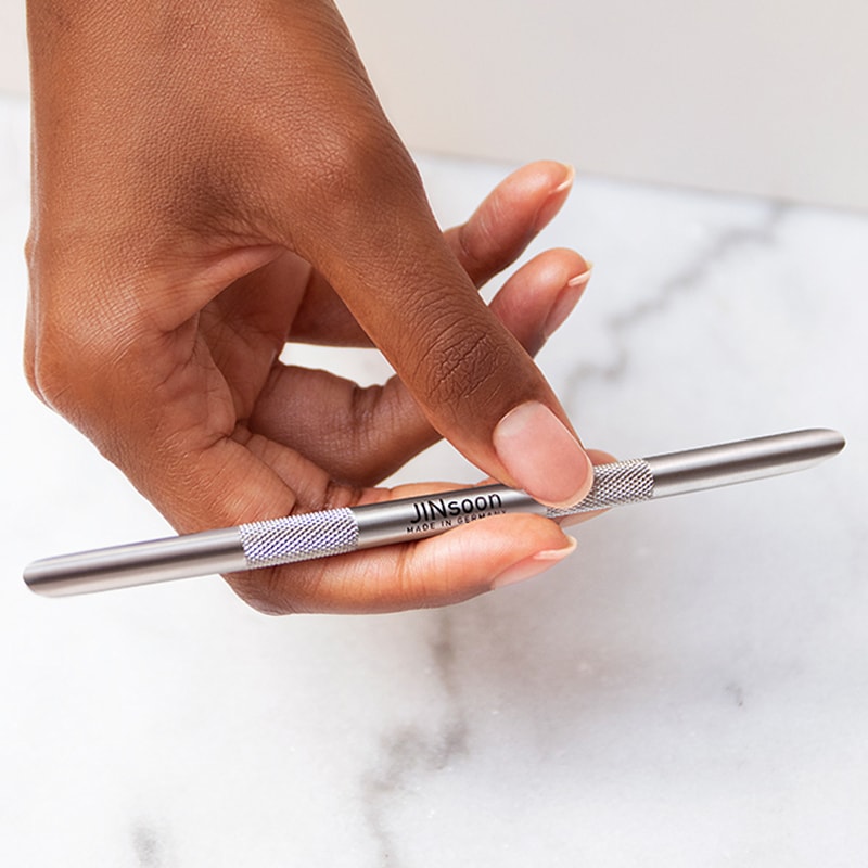 JINsoon HyperCare Cuticle Pusher + Reducer in Model's hand