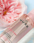 Nuxe Very Rose Delicate Cleansing Oil bottle close-up with rose