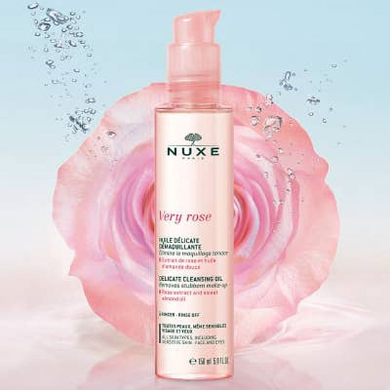 Nuxe Very Rose Delicate Cleansing Oil bottle in front of rose