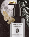 Lifestyle shot of Upclose shot of Sangre de Fruta Botanical Body Serum Jasmin de Nuit (200 ml) with moth and beetle on bottle and full moon with stars in the background