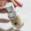 Futuna Skin Porte Per Vitalita Face & Eye Serum shown with model's hand