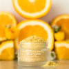 Athar’a Pure Indian Glow Face Scrub beauty shot in front of oranges