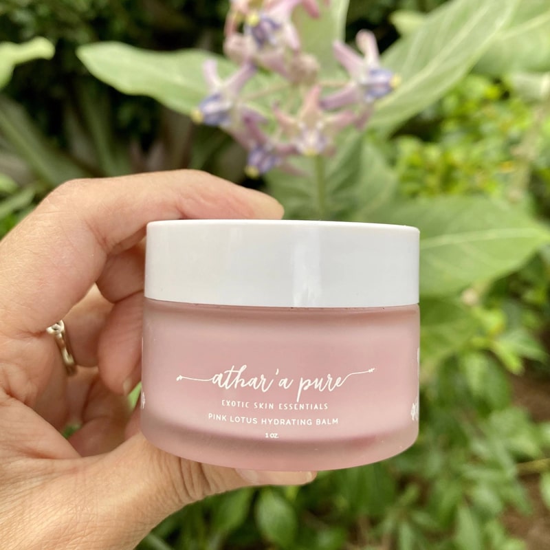 Athar’a Pure Pink Lotus Hydrating Balm lifestyle shot in model&#39;s hand