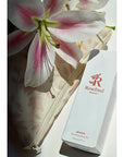 Rosebud Woman Anoint Nourishing Body Oil beauty shot with flower and bag (not included)
