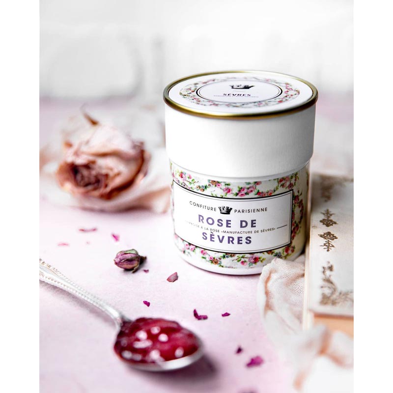 Confiture Parisienne Rose de Sevres beauty shot showing jam in a spoon and a rose in the background
