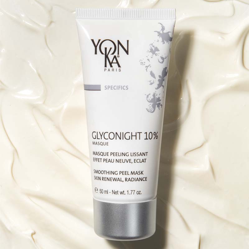 Yon-Ka Paris Glyconight 10% Masque (50 ml) lifestyle shot with masque texture in the background