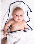 Malabar Baby Luxe Silky Soft Bamboo Cotton Swaddle – Navy Pom Pom Trim shown wrapped around baby (not included)