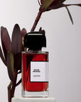 BDK Parfums Rouge Smoking Eau de Parfum with plant beside (not included)