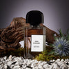 Beauty shot of BDK Parfums Gris Charnel Eau de Parfum (100 ml) in front of wood