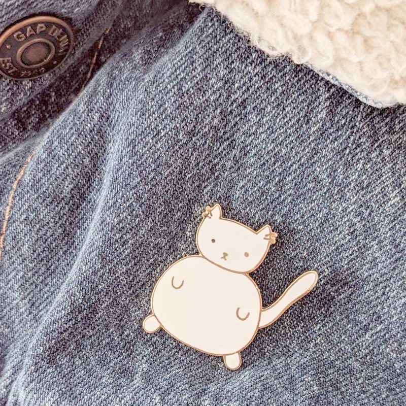 Mimi &amp; August White Cat Enamel Pin shown on a denim jacket (not included)