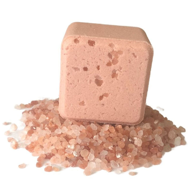 Onsen Saru Hot Spring Bath Fizz cube on a stack of pink Himalayan salt