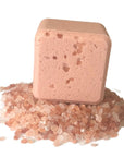 Onsen Saru Hot Spring Bath Fizz cube on a stack of pink Himalayan salt