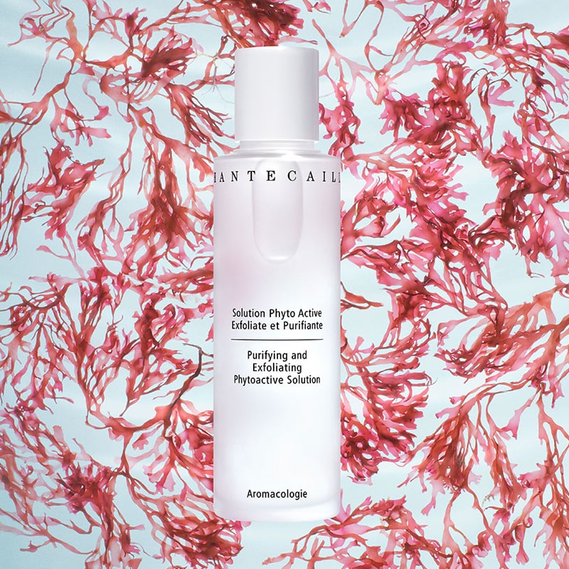 Chantecaille Purifying and Exfoliating Phytoactive Solution beauty shot with pink flowers in background