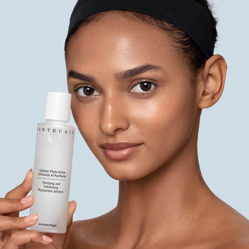 Chantecaille Purifying and Exfoliating Phytoactive Solution pictured with model holding bottle