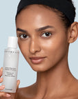 Chantecaille Purifying and Exfoliating Phytoactive Solution pictured with model holding bottle
