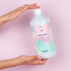 Shot of Kerzon Laundry Soap - Petit Grain bottle in models hand