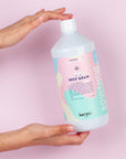 Shot of Kerzon Laundry Soap - Petit Grain bottle in models hand