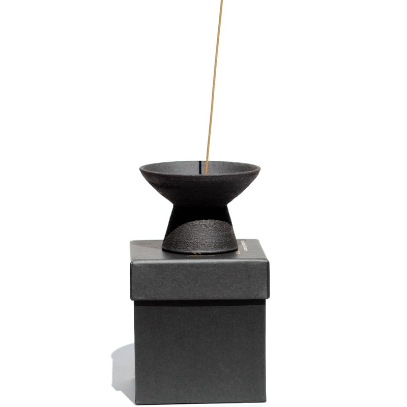 Ume Incense Shibui Raw Black Stoneware Incense Holder side view on box with stick incense (not included)