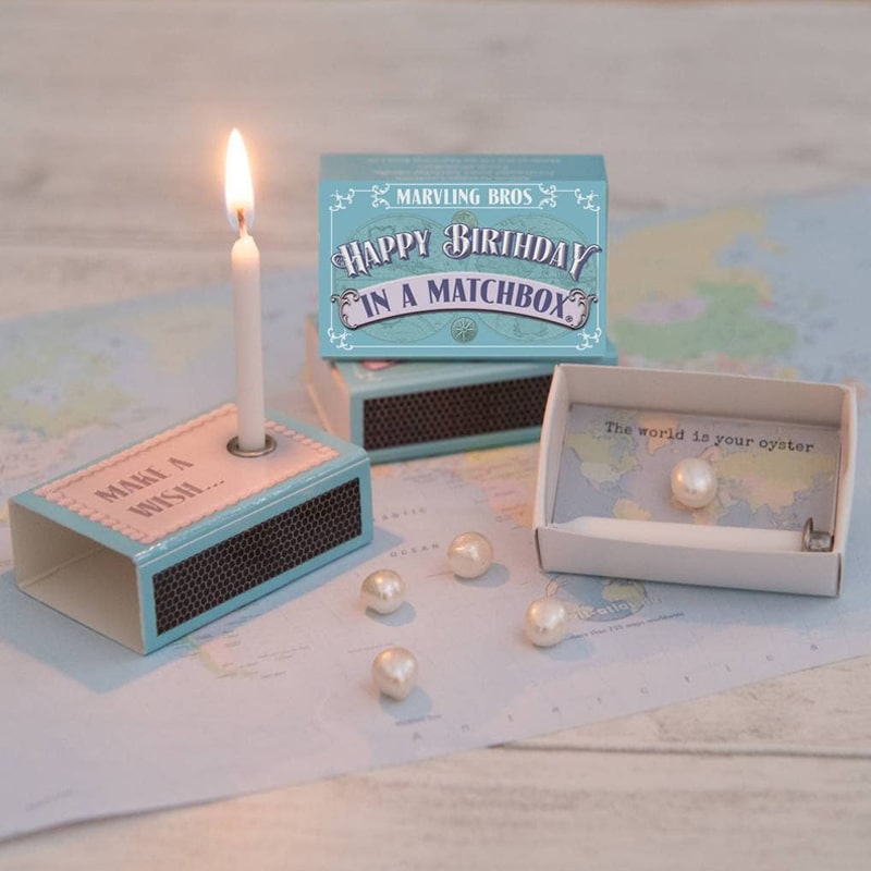 Marvling Bros Ltd Happy Birthday Pearl In A Matchbox showing open matchbox and lit candle (included) and pearl in box (additional pearls not included)