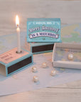 Marvling Bros Ltd Happy Birthday Pearl In A Matchbox showing open matchbox and lit candle (included) and pearl in box (additional pearls not included)