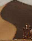 Gas Bijoux Sable d’Ambre Eau de Parfum beauty shot in front of a sand dune