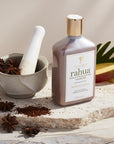 Rahua by Amazon Beauty Rahua Scalp Exfoliating Shampoo beauty shot on marble slab with ingredients around
