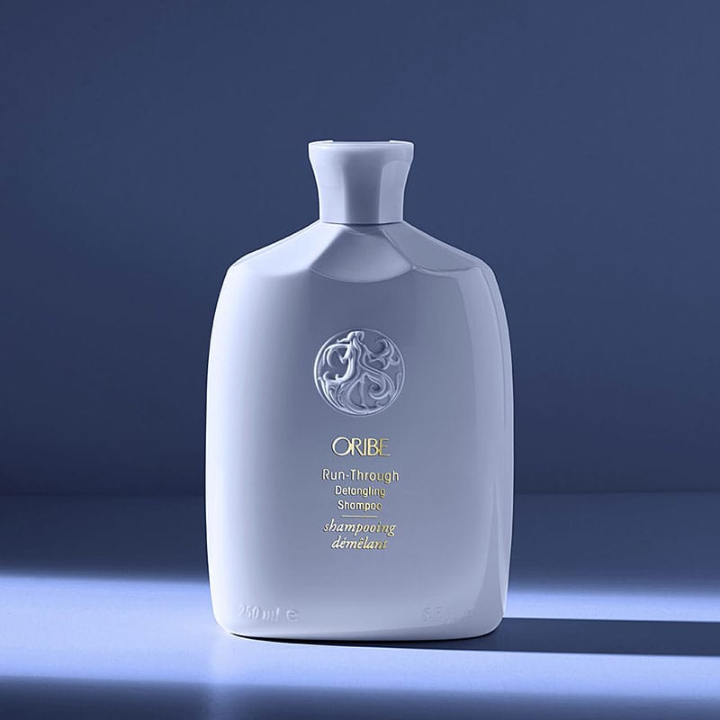 Oribe Run-Through Detangling Shampoo - dramatic beauty shot on shadow background