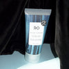 Beauty Shot of R+Co Velvet Curtain Cotton Touch Texture Balm in front of a black Velvet Curtain