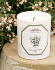Lifestyle shot of Carriere Freres Verbena Candle with flowers in background