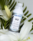 R+Co Bio Dome Hair Purifier + Anti-Pollutant Spray beauty shot with plants and flowers