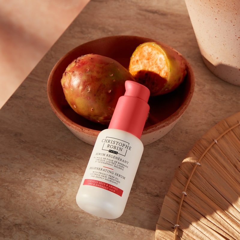 Christophe Robin Regenerating Serum with Prickly Pear Oil showing product by bowl with prickly pears