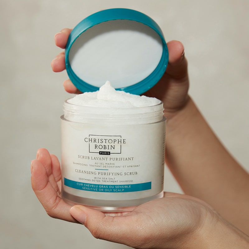 Christophe Robin Cleansing Purifying Scrub with Sea Salt  showing model holding open jar