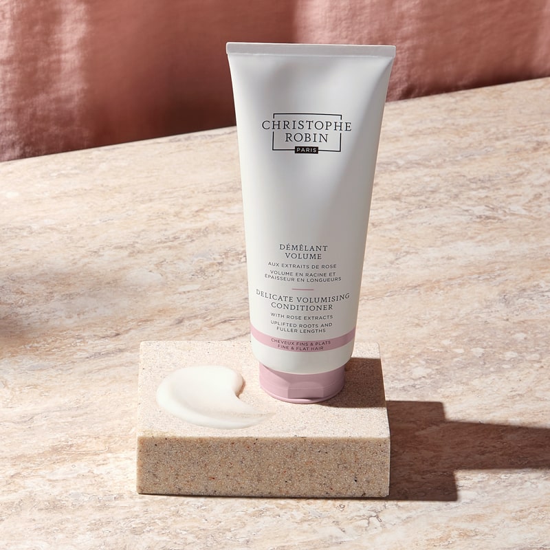 Christophe Robin Delicate Volume Conditioner with Rose Extracts showing tube beside a smear of product