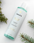 Philip B. Nordic Wood Hair + Body Shampoo beauty shot with evergreen branches